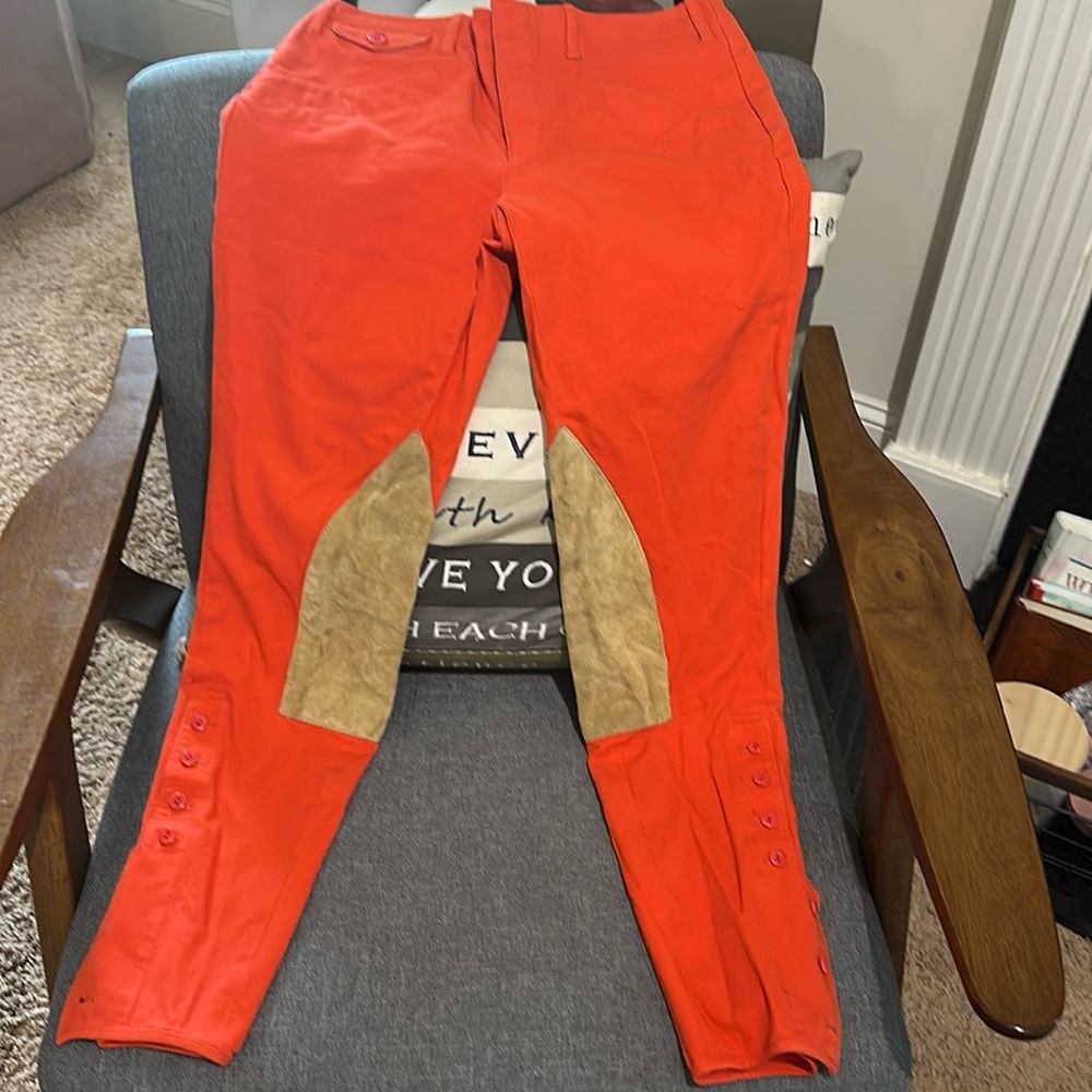Ralph Lauren:Cropped pants orange and Swede trim, buttons on side of the calves